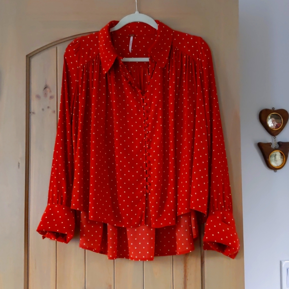 Free People women's long sleeved blouse with back tapering in rust color.
